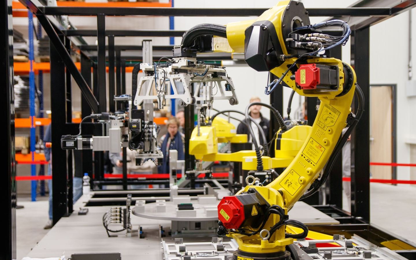 Industrial robotic arm operating in a modern manufacturing facility.